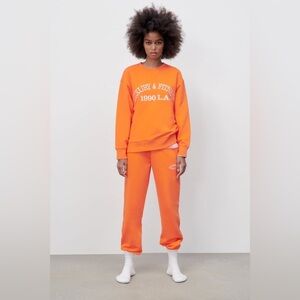 Zara "Luxury & Fitness" Sweatshirt (Size M, Orange)